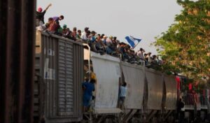 Mexican railway operator halts trains as migrants climb aboard, get ...