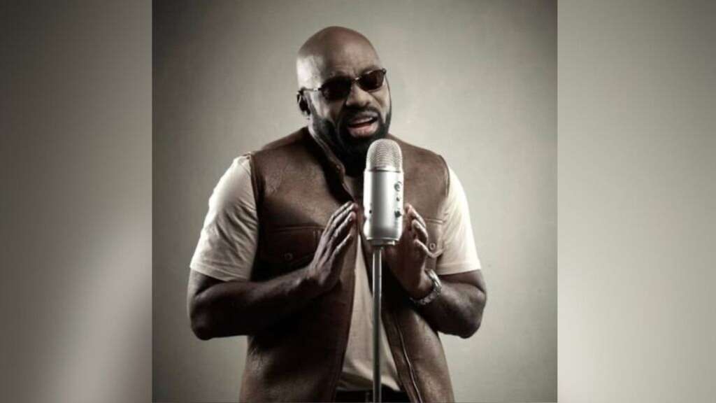 Richie Stephens on top with Statue of a Fool - Jamaica Observer
