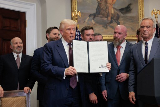 Trump signs order to impose higher tariffs on dozens of economies