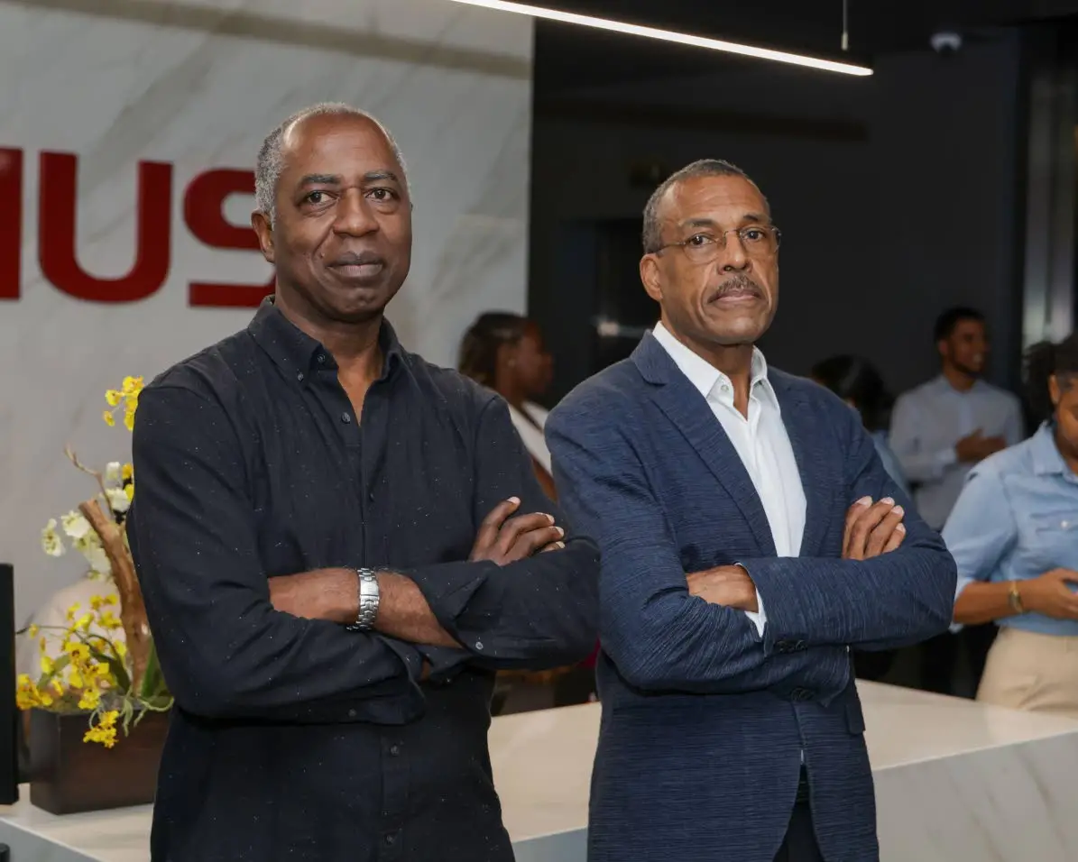 Leo Williams (left), executive director at Williams and Associates, and long-time friend Gerard Johnson, former regional head of the Inter American Development Bank, are intrigued by Subira Toppin’s presentation at the recent CARAIA mixer, Cocktails and Conversations. .