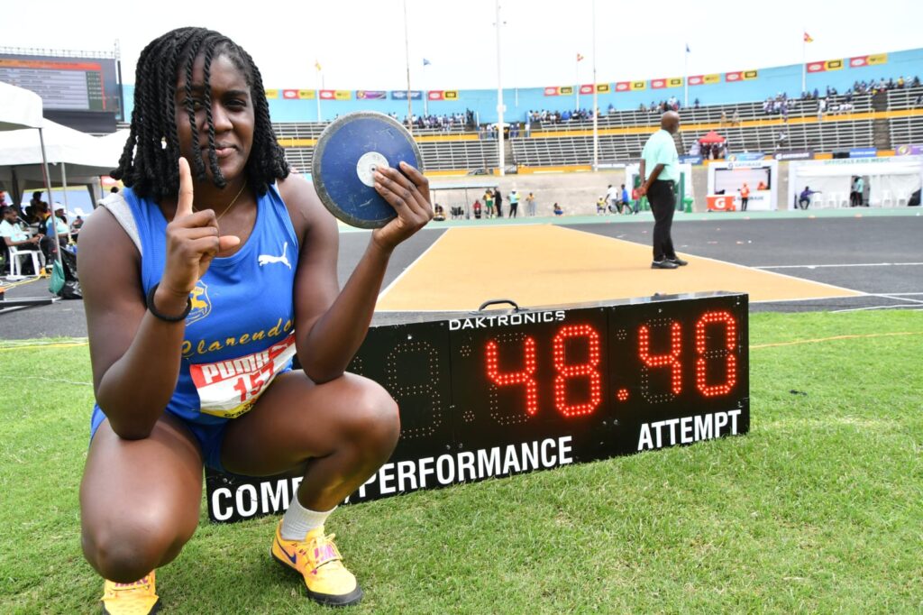 Clarendon College’s Jamelia Young won her second gold medal at the ISSA/GraceKennedy Boys and Girls Championships in style on Friday, throwing 48.40m to break the Girls Class 2 discus throw record despite feeling discomfort in her throwing hand.