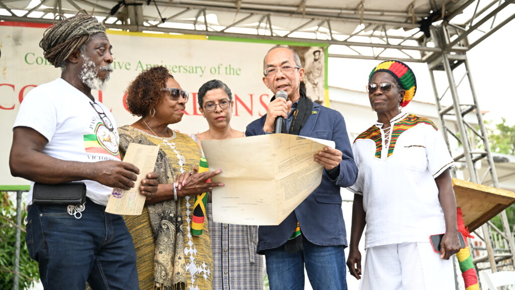 Minister of National Security Dr Horace Chang, on Good Friday, formally handed over land titles to the Rastafari Coral Gardens Benevolent Society, as restitution by the State for the 1963 Coral Gardens incident in St James.