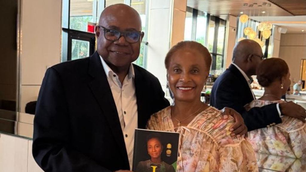 Dr Patricia Smith presents Tourism Minister with copy of her book ‘I Persist’