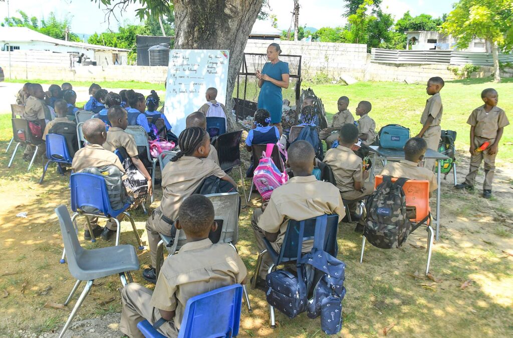 Hot classroom tent abandoned at Holland Primary Students, teachers turn to trees for shade