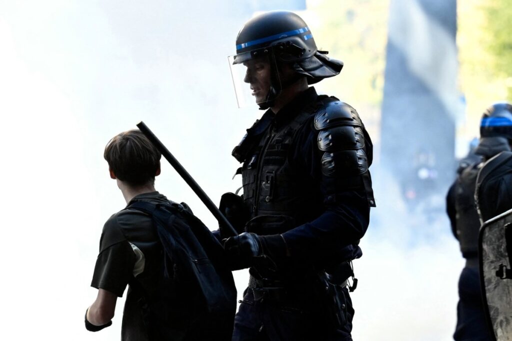 Teenager loses hand picking up grenade in France school protests